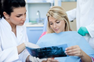 Zahnärztin erklärt einer Patienten dein Eingriff
